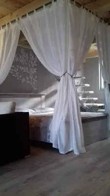 a bedroom with a canopy bed with curtains at Sunview Sveti Stefan in Sveti Stefan