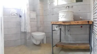 a bathroom with a white toilet and a sink at Sunview Sveti Stefan in Sveti Stefan