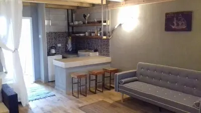 a living room with a couch and a kitchen at Sunview Sveti Stefan in Sveti Stefan