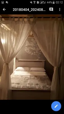a bedroom with a bed with a curtain at Sunview Sveti Stefan in Sveti Stefan