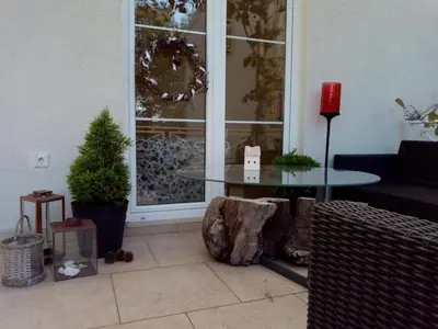 a living room with a table and a window at Suntime Villa 7 in Tivat