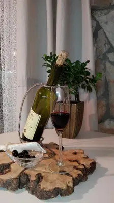 a bottle of wine and a glass on a table at Suntime Villa 7 in Tivat