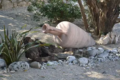 a statue of a trumpet sitting on a pile of rocks at Suntime Villa 7 in Tivat