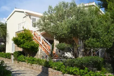 a house with a staircase in front of it at Suntime Villa 7 in Tivat