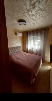 a bedroom with a bed in front of a window at Apartment MJ in Budva