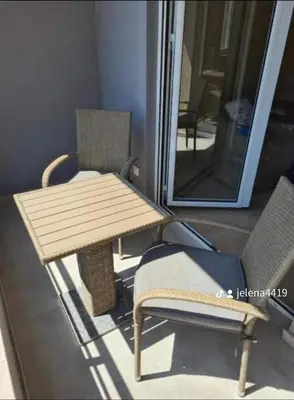 a wooden table and a chair and a mirror at Apartment MJ in Budva