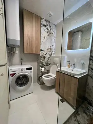 a bathroom with a washing machine and a sink at Apartment MJ in Budva