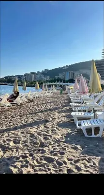 a bunch of lounge chairs on a beach at Apartment MJ in Budva