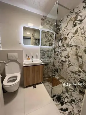 a bathroom with a toilet and a sink and a shower at Apartment MJ in Budva