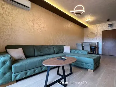 a living room with a green couch and a table at Apartment MJ in Budva