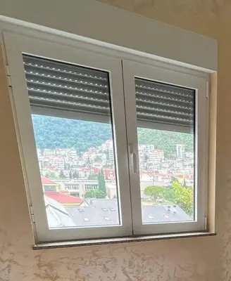 two windows with blinds in a room at Apartment MJ in Budva