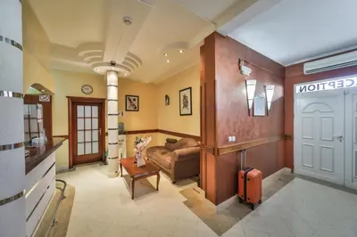a living room with a waiting room with a suitcase at Garni Hotel Koral in Budva