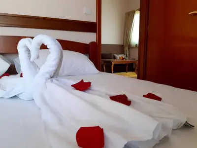 two swans made out of towels on a bed at Garni Hotel Koral in Budva