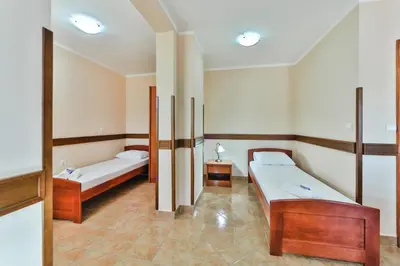 a room with two beds in a room at Garni Hotel Koral in Budva