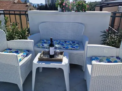 a bottle of wine sitting on a table on a patio at Apartments Tamara in Budva