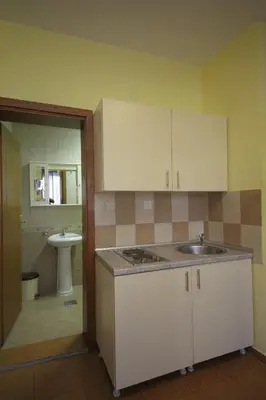 an empty kitchen with a sink and a bathroom at Apartments Tamara in Budva