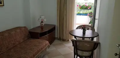 a living room with a couch and a table and a window at Apartments Tamara in Budva