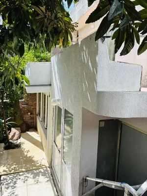 a white building with a staircase on the side of it at Casa Verde in Boreti