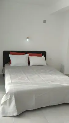 a large white bed with two pillows on it at Casa Verde in Boreti