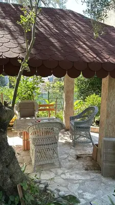a patio with two chairs and an umbrella at Casa Verde in Boreti