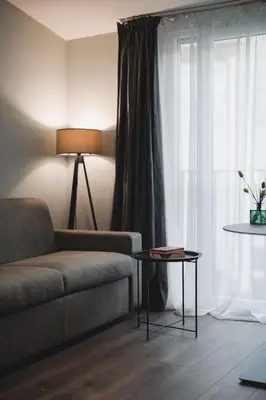 a living room with a couch and a window at Moon apartment 2 in Podgorica