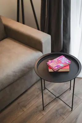 a black table with two books on it next to a couch at Moon apartment 2 in Podgorica