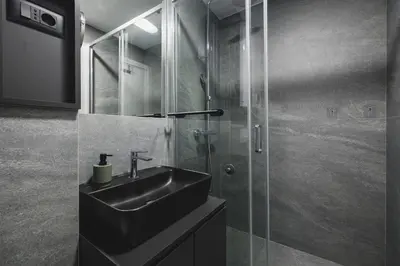 a bathroom with a sink and a glass shower at Moon apartment 2 in Podgorica