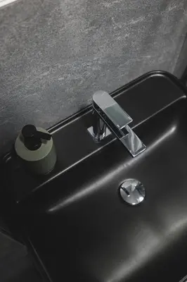 a black sink with a soap dispenser on it at Moon apartment 2 in Podgorica