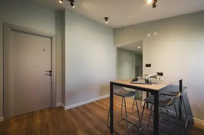 a room with a table and chairs and a door at Moon apartment 2 in Podgorica