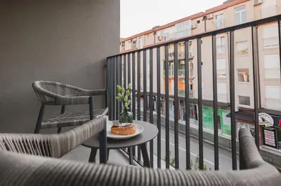 a balcony with chairs and a table and a window at Moon apartment 2 in Podgorica