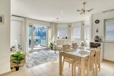 a kitchen and dining room with a table and chairs at Kotor Vista Seaview apartment by MN Property in Muo