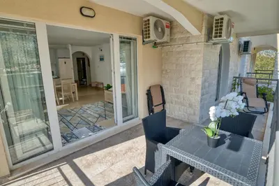 a patio with a table and chairs on a house at Kotor Vista Seaview apartment by MN Property in Muo