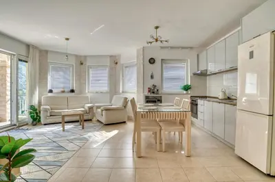 a kitchen and living room with a table and chairs at Kotor Vista Seaview apartment by MN Property in Muo