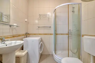 a bathroom with a shower and a toilet and a sink at Kotor Vista Seaview apartment by MN Property in Muo