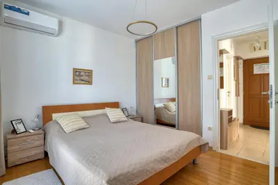 a bedroom with a large bed and a hallway at Kotor Vista Seaview apartment by MN Property in Muo