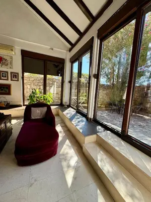 a living room with a chair and large windows at Waterfront Villa Magnolia in Kotor