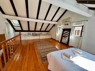 a room with a bed and a wooden floor at Waterfront Villa Magnolia in Kotor