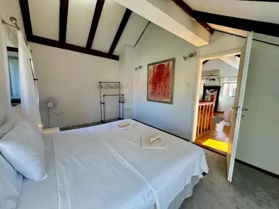 a bedroom with a large white bed in a room at Waterfront Villa Magnolia in Kotor