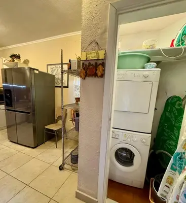 a kitchen with a washing machine and a refrigerator at Waterfront Villa Magnolia in Kotor