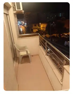 a white chair sitting on the ledge of a balcony at Stan Budva Rozino in Budva