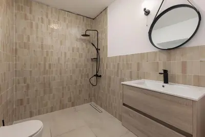 a bathroom with a sink and a mirror at Villa Magic Stone in Šišići