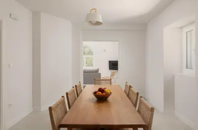 a dining room with a wooden table with a bowl of fruit at Villa Magic Stone in Šišići
