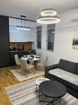 a living room with a couch and a table at Emel Apartman in Ulcinj