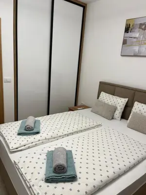 two beds with towels sitting on top of them at Emel Apartman in Ulcinj