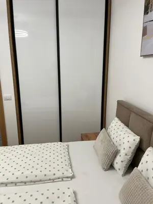 a bed with two pillows on top of it at Emel Apartman in Ulcinj