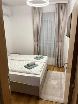 a bedroom with a bed with two towels on it at Emel Apartman in Ulcinj