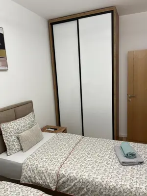 a bedroom with a bed and a large sliding glass door at Emel Apartman in Ulcinj