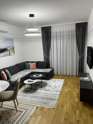a living room with a couch and tables at Emel Apartman in Ulcinj
