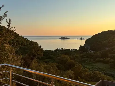 a view of the ocean at sunset from a balcony at Villa Nova Premium Apartment No 8 in Petrovac na Moru