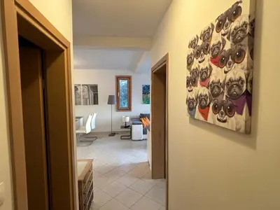 a hallway with a painting of eyes on the wall at Villa Nova Premium Apartment No 8 in Petrovac na Moru